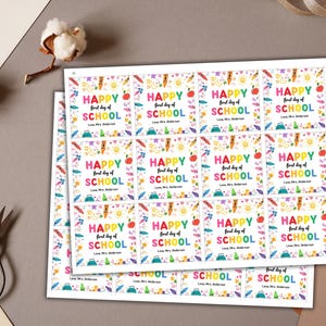 May include: Sheets of colorful "Happy First Day of School" stickers. Each sticker features text, an apple, a pencil, and other school-themed graphics. The stickers are printed on white paper.