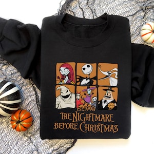 May include: Black sweatshirt featuring a graphic of characters from "The Nightmare Before Christmas." The design includes images of Sally, Jack Skellington, Zero, Oogie Boogie, and others, with the text "The Nightmare Before Christmas" and "est. 1993."