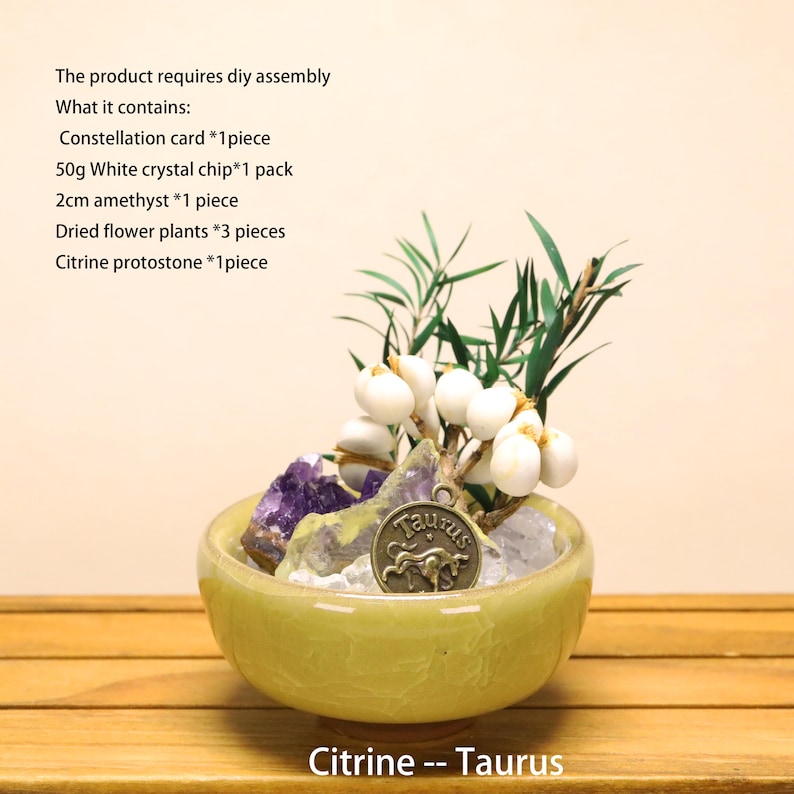 May include: A light green ceramic bowl containing white crystal chips, a purple amethyst stone, a citrine stone, dried green plants, white berries, and a bronze-colored Taurus zodiac charm. Text lists contents including 50g crystal chips and 2cm amethyst.