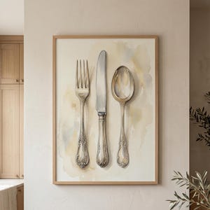 May include: A framed watercolour wall art print featuring a silver fork, knife, and spoon arranged vertically. The cutlery has ornate, detailed handles and is set against a soft, neutral-toned background with subtle beige and grey watercolour washes.