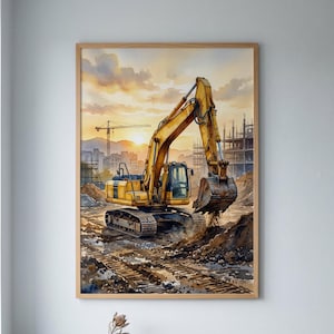May include: A framed watercolour painting depicting a yellow excavator working on a construction site at sunset. The scene features a large crane in the background, unfinished building structures, and deep tyre tracks in the dirt ground.