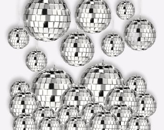 May include: A set of silver disco ball ornaments of various sizes. The ornaments are made of mirrored tiles and are perfect for adding a touch of sparkle to any party or event.