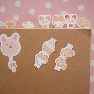 Op de afbeelding: Een set kleurrijke stickers met dierenmotieven, met een konijn, een hond, een kat en een hamster. De stickers zijn perfect om dagboeken, planners en andere papieren producten te versieren.