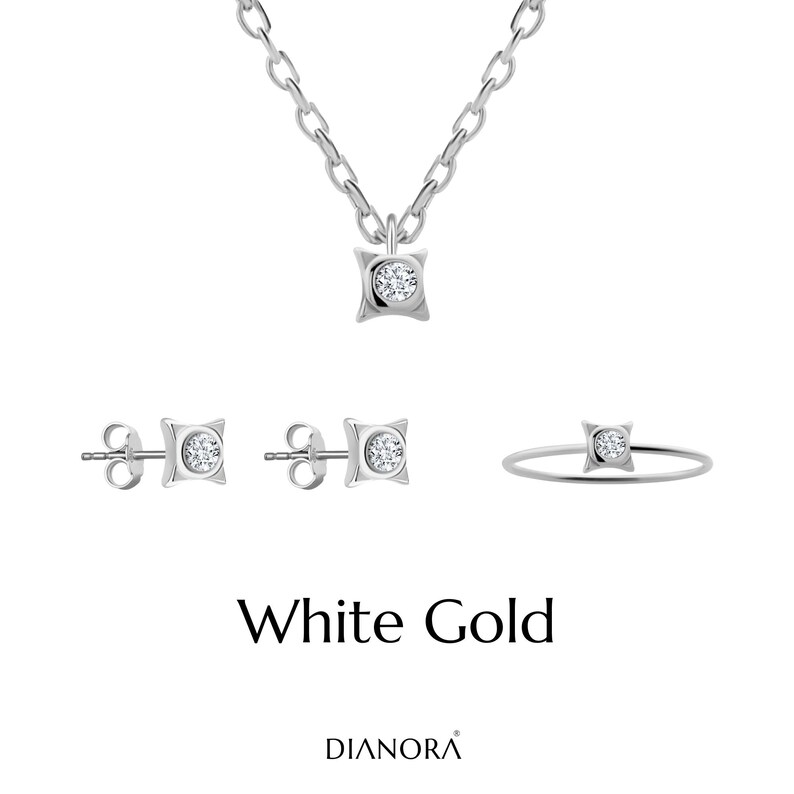 May include: A white gold jewelry set with a necklace, earrings, and a ring. Each piece features a square-shaped pendant with a small diamond in the center.