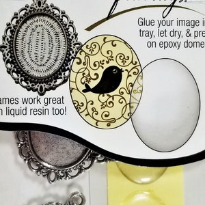 May include: A set of three silver metal pendant frames with ornate designs. The frames are designed to be used with epoxy resin. The package includes three clear epoxy domes. The package also includes a sticker with the text "Sweet Beads" and "Fundamental Findings".