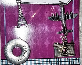 E-232: Four Antiqued Silver Travel Charms-"Discover", Eiffel Tower, Camera, and an Airplane