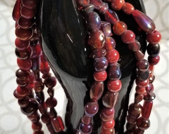 BF-317;  Multi Strand (4) Glass Beads in Various Sizes and Colors of Red, Burgundy, Oranges- With a Touch of the Iridescent- Beautiful!