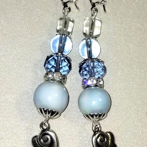 MJ-130; A Pair of Blue and Silver Earrings- Faceted Blue Glass, Blue and Clear Beads Silver Wings and Silver Lever Back Closures