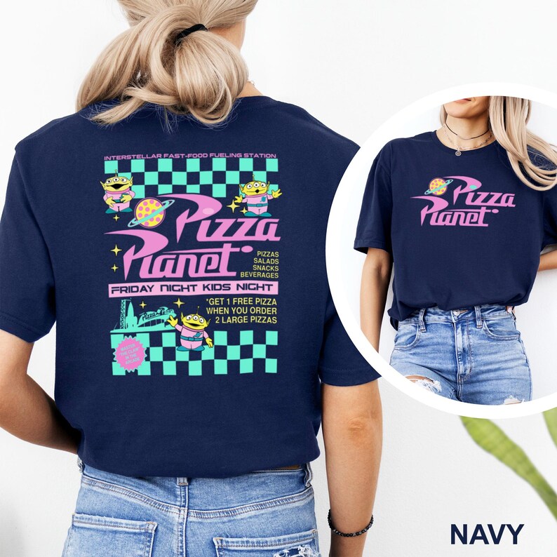 May include: Navy blue t-shirt featuring the text "Pizza Planet" in pink and a graphic of a planet with a pizza. The back of the shirt has a larger design with aliens, the words "Pizza Planet", and the text "Friday Night Kids Night".