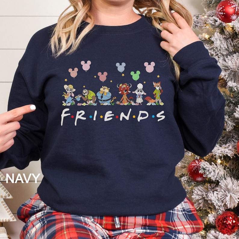 May include: Navy blue sweatshirt featuring the word "FRIENDS" in white, with cartoon character illustrations above. The sweatshirt has a crew neck and long sleeves. Mickey Mouse balloons are above the characters.