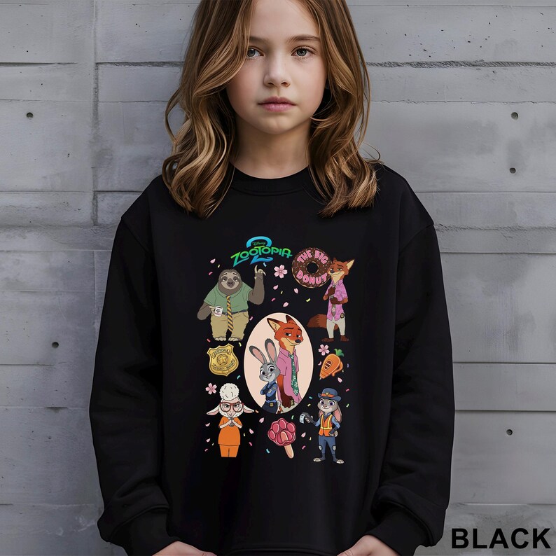 May include: Black sweatshirt featuring characters from the animated film Zootopia. The design includes Judy Hopps, Nick Wilde, and other characters, along with the text "Zootopia 2" and "The Big Donut". The word "BLACK" is printed at the bottom right.
