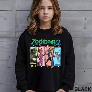 May include: Black sweatshirt with the text "ZOOTOPIA 2" and a graphic of four animated characters in colourful rectangular panels. The word "BLACK" is printed at the bottom right of the sweatshirt.
