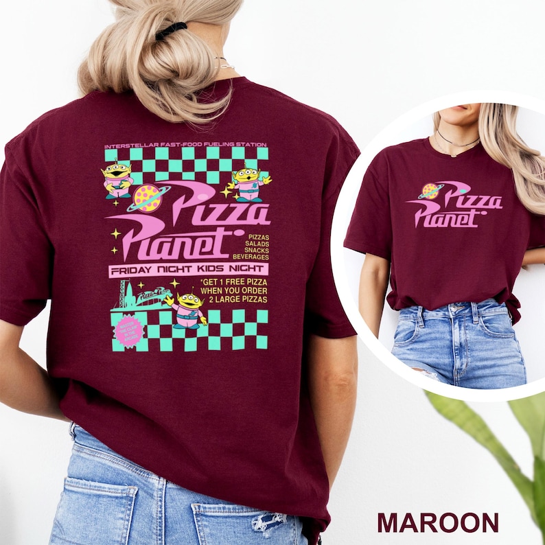 May include: Maroon t-shirt featuring the Pizza Planet logo and graphics. The design includes the text "Pizza Planet", "Pizzas, Salads, Snacks, Beverages", and "Friday Night Kids Night". The shirt also has a graphic of a space alien.