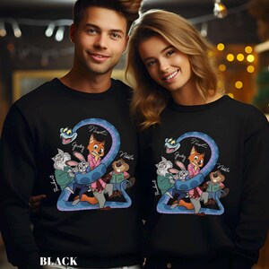 May include: Black sweatshirts featuring a cartoon design with a blue snake and several animal characters. The design includes the names "Judy", "Nick", and "Nibbles". The word "BLACK" is printed at the bottom.