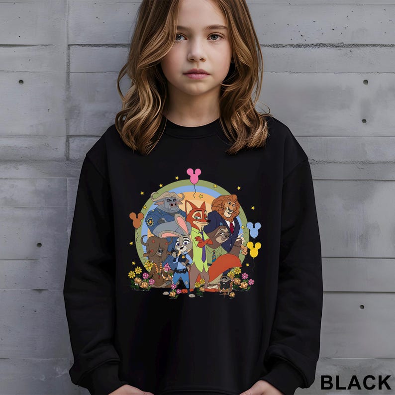 May include: Black sweatshirt with a vibrant cartoon illustration of animal characters, including a fox and lion, set within a circular design with a rainbow and stars. The word "BLACK" is printed at the bottom right of the garment.