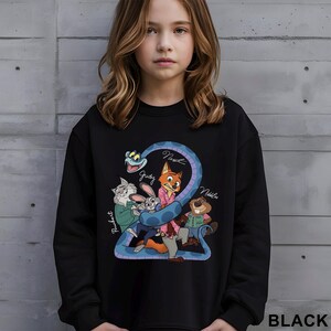 May include: Black sweatshirt featuring a colorful cartoon graphic of characters from a movie. The graphic includes a blue snake, a fox, a rabbit, a beaver, and a cat. The word "BLACK" is printed in white at the bottom right.
