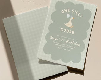May include: A light green birthday invitation with a scalloped edge and a matching envelope. The invitation features a cartoon goose holding a balloon and the text "One Silly Goose". The invitation also includes the text "Hayes' 1st Birthday".