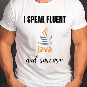 May include: White t-shirt with the text "I SPEAK FLUENT Java and sarcasm". The design includes a stylized orange and blue coffee cup graphic. The shirt is a classic crew neck style.