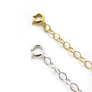 May include: Two chain extenders, one gold and one silver, with lobster claw clasps.
