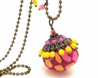 Long ball pendant necklace in colorful fabric, beads and filigree woven with satin cords