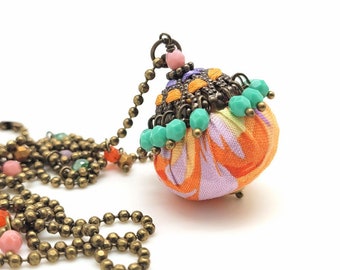 Sautoi ball, pendant in colorful fabric, glass beads and filigree woven with satin threads