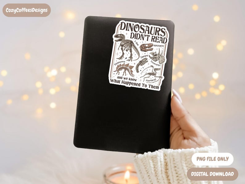 May include: A black electronic device with a sticker that reads "DINOSAURS DIDN'T READ" featuring dinosaur illustrations. The sticker also includes the text "and we know What Happened To Them". The image is a digital download.