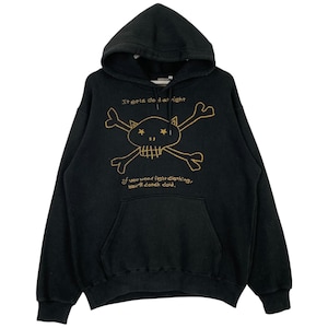 May include: Black hooded sweatshirt with a gold skull and crossbones graphic. The text "It gets cold at night" and "If you wear light clothing, you'll catch cold." is printed below the graphic.