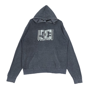 May include: A charcoal gray hoodie with a kangaroo pocket and a drawstring hood. The front features a white barcode-style graphic with the letters "DC" and the text "8 DESHOECOUSA '87". The sweatshirt is made of a soft, comfortable material.