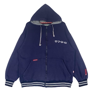May include: A navy blue zip-up hoodie with a gray hood and white embroidered designs on the front. The hoodie has a ribbed hem and cuffs.