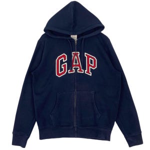 May include: Navy blue zip-up hoodie with a hood and front pockets. The word "GAP" is displayed across the chest in red letters with a white outline. The hoodie is made of a soft, comfortable material.