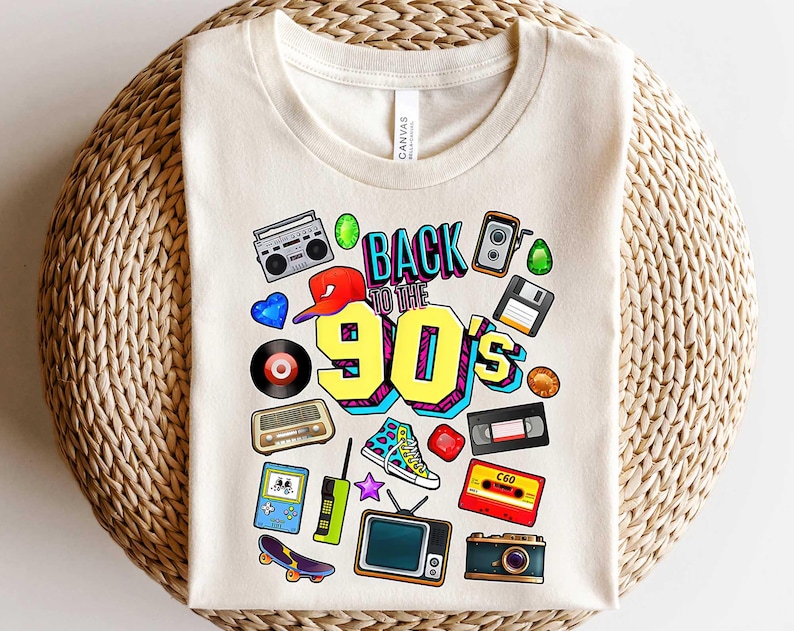May include: A white t-shirt with a colorful graphic design featuring the text "Back to the 90's" and retro icons like a boombox, a camera, a cassette tape, and a video game console.