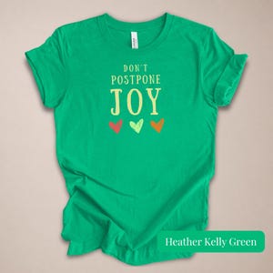 Motivational Quote Tee Women Positive Message Shirt Dont Postpone Joy Graphic Design Inspirational Top Happy Vibes Joyful Apparel Mental Health Gift Meaningful Message Uplifting Design Casual Comfort Style Daily Motivation Wear Self Care