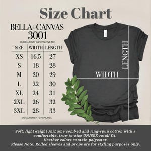 May include: A Bella+Canvas 3001 unisex jersey short sleeve t-shirt size chart with a dark gray t-shirt graphic. The chart lists sizes XS through 3XL with corresponding width and length measurements in inches. Text includes fabric details.