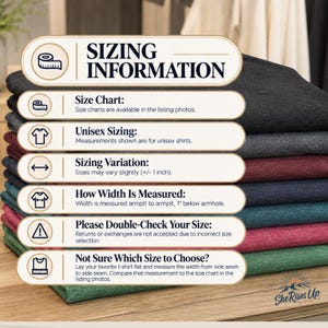 May include: A stack of folded t-shirts in various colors including black, grey, maroon, navy, teal, and green. An overlay graphic provides sizing information, including instructions on how to measure width from armpit to armpit, plus 1 inch.