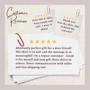 May include: Three white paper notes featuring customer reviews with five-star ratings. The text includes 'Customer Reviews', 'Love this T-shirt. Very comfy and soft. I wear it often!', 'Thank you love the shirt, just ordered my 3rd one!!', and more.