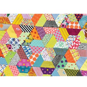May include: A patchwork quilt featuring a dense arrangement of multi-colored fabric hexagons and trapezoids. The textile displays a variety of patterns including polka dots, stripes, floral prints, and geometric shapes in vibrant shades of yellow, pink, orange, blue, and green.