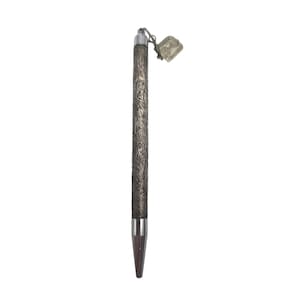 May include: A silver-toned ballpoint pen featuring an intricate, embossed floral pattern along the barrel. The pen has a smooth, polished metal tip and a small, rectangular metal tag attached to the top by a thin chain, displaying a menorah symbol.