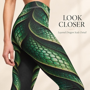 May include: High-waisted leggings featuring a green and black layered dragon scale pattern. The text LOOK CLOSER and Layered Dragon Scale Detail is printed on the right side. The design displays a repeating reptile skin texture.