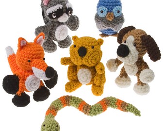 May include: A set of crocheted animal toys, including a fox, raccoon, owl, dog, and a snake. The toys are made with different colored yarn and have realistic features.