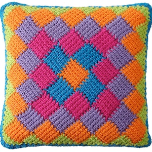 May include: A colorful crocheted pillow with a diamond pattern in shades of green, orange, purple, pink, and blue.