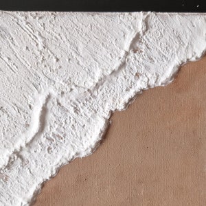 May include: Abstract painting on canvas with white textured paint on the left side and brown canvas on the right side.