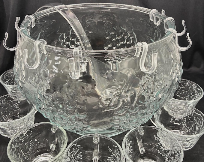 Featured listing image: Indian glass celebration crystal Punchbowl clear with grapes design in glass with 8 cups hanger hooks, and a plastic ladle.
