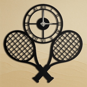 May include: Black metal wall clock with Roman numerals and tennis rackets. The clock face is round with a black center and hands. Two tennis rackets are crossed below the clock, creating a sports-themed wall decoration.