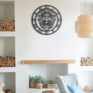 May include: A black metal wall clock featuring a lion's head design. The clock has Roman numerals around the outer edge and a detailed lion's face in the center. The clock is mounted on a white wall.