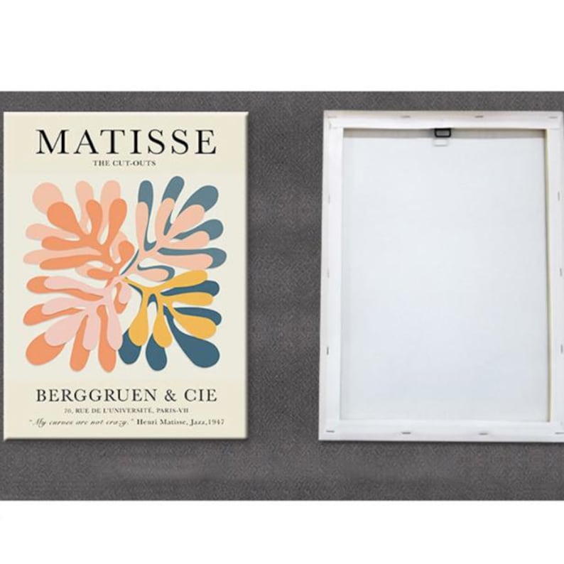 May include: A white canvas print with a colorful abstract design by Henri Matisse. The design features a stylized floral motif in shades of pink, yellow, blue, and green. The text "MATISSE THE CUT-OUTS BERGGRUEN & CIE 70 RUE DE L'UNIVERSITE, PARIS-VIH "My curves are not crazy" Henri Matisse, Jazz, 1947" is printed below the design.
