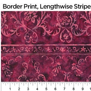 May include: A close-up of a burgundy fabric with a white floral pattern. The fabric has a lengthwise stripe with a smaller floral pattern. The fabric is measured in inches.