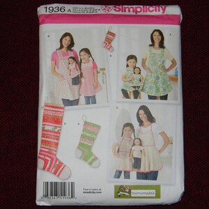May include: A Simplicity sewing pattern for making Christmas aprons and stockings. The pattern includes instructions for making aprons for adults and children, as well as stockings for dolls. The pattern is illustrated with photos of the finished garments.