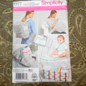May include: A Simplicity sewing pattern for making baby items. The pattern includes instructions for making a diaper bag, a nursing cover, a car seat canopy, a bib, and a storage basket. The pattern number is 1177.