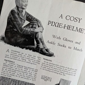 May include: A vintage knitting pattern page titled A COSY PIXIE-HELMET With Gloves and Ankle Socks to Match. It features a black and white illustration of a person wearing the set, along with printed instructions, material lists, and a ruler.