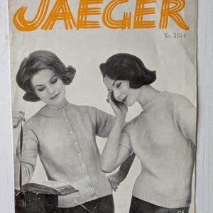 May include: Vintage magazine cover featuring two women in light-colored sweaters. The word "JAEGER" is in orange block letters at the top. The text "Jaeger Orlon" is at the bottom. The magazine is No. 3614 and the price is 6d.